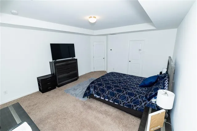 a bedroom with bed and window