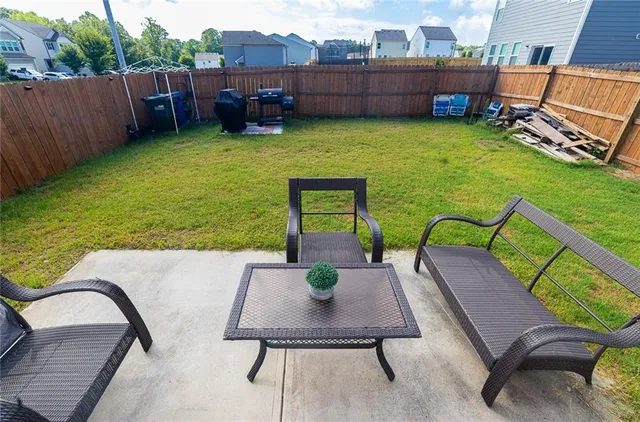 a view of a chairs and table in patio