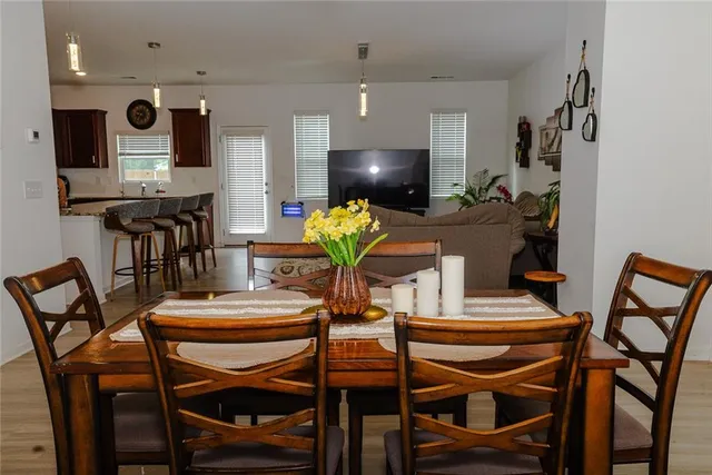 a view of a dining room with furniture and wooden floor