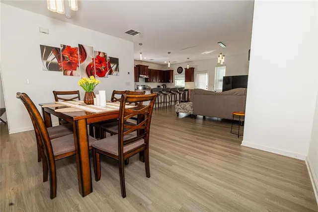 a view of a dining room with furniture and wooden floor