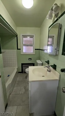 a bathroom with a sink a toilet and mirror
