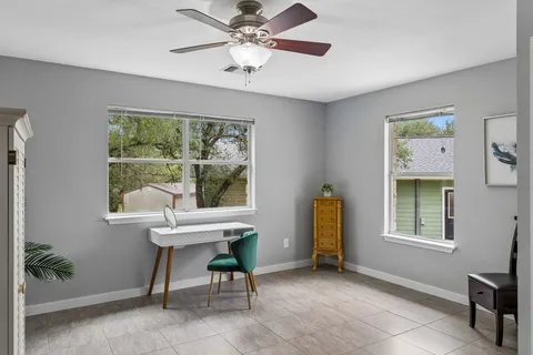 a view of a workspace with furniture and a window