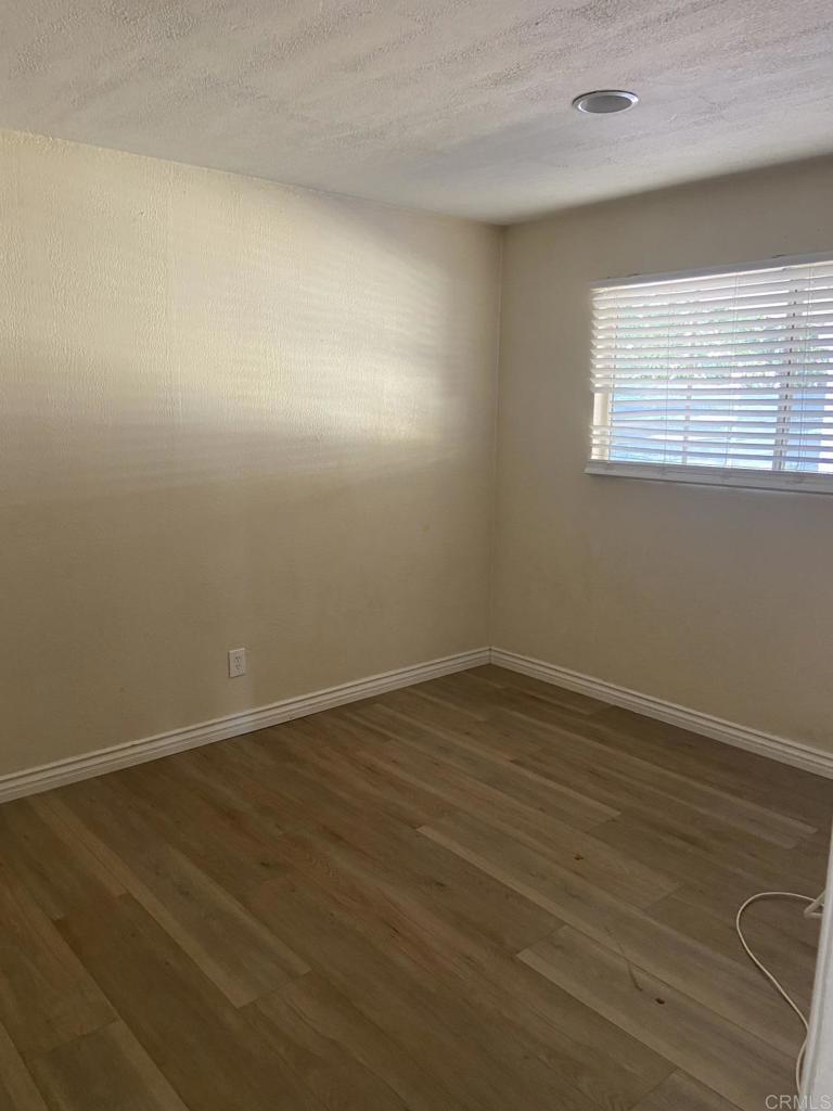 917 Broadview Street Spring Valley, CA 91977 - Photo 10 of 14 a view of an empty room with wooden floor and a window
