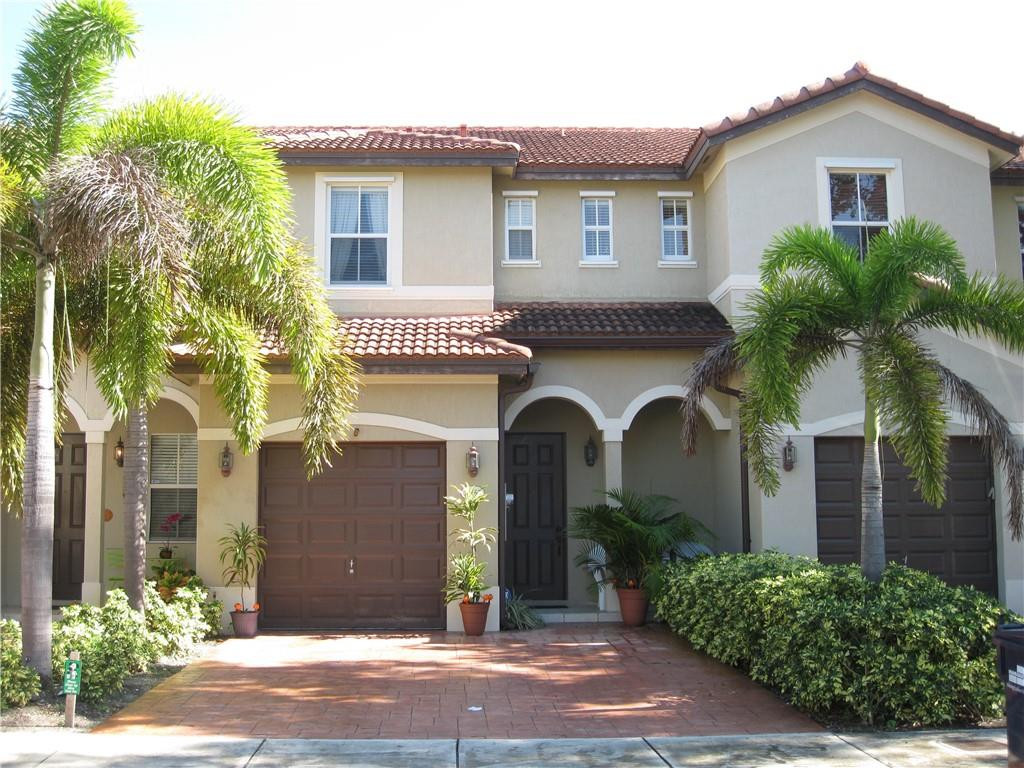 20767 Northeast 10th Path, Unit 20767 Miami, FL 33179 - Photo 1 of 26 a front view of a house with garden