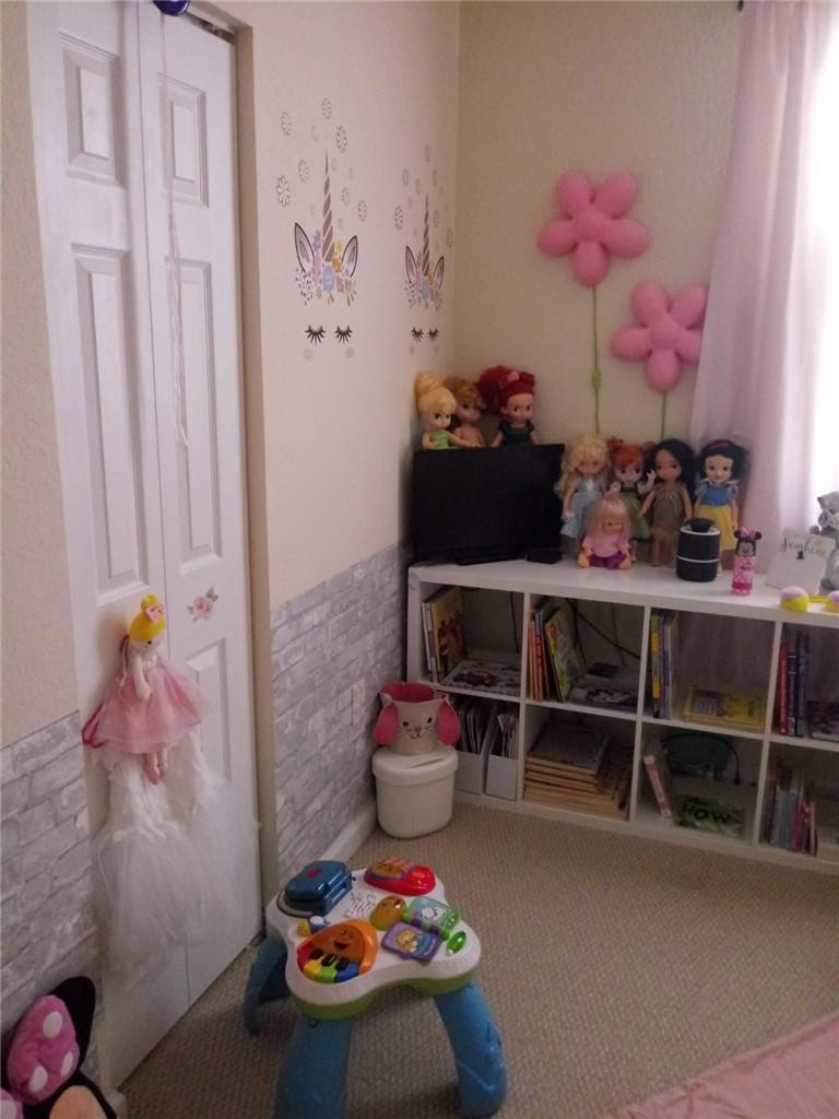 20767 Northeast 10th Path, Unit 20767 Miami, FL 33179 - Photo 14 of 26 a room with furniture and toys