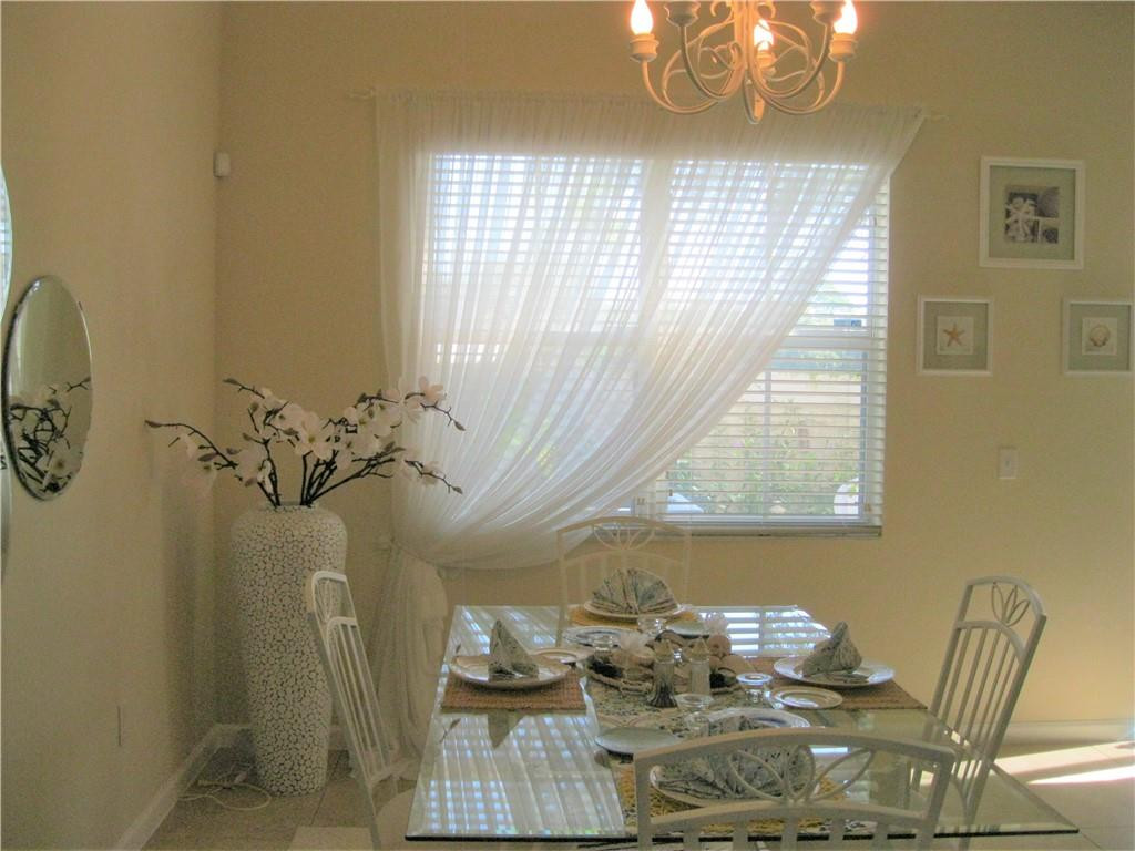20767 Northeast 10th Path, Unit 20767 Miami, FL 33179 - Photo 3 of 26 a view of a dining room with furniture window and outside view