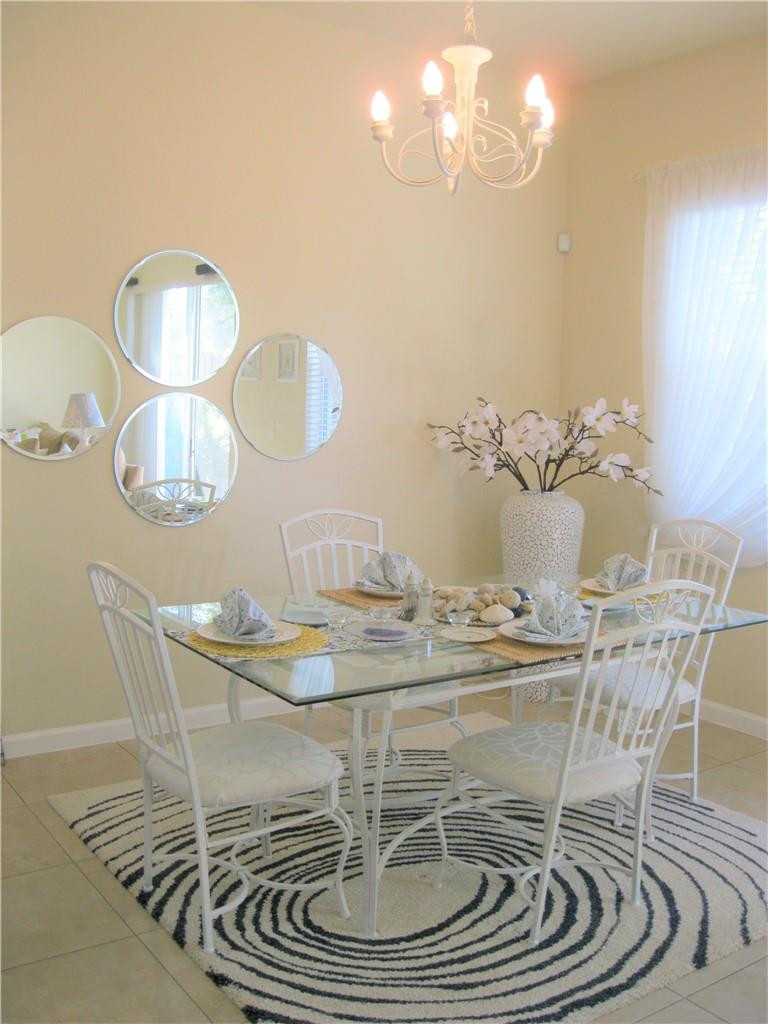 20767 Northeast 10th Path, Unit 20767 Miami, FL 33179 - Photo 5 of 26 a dining room with wooden floor