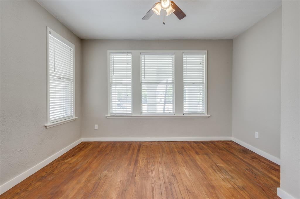 2309 Wesley Street, Unit D Greenville, TX 75401 - Photo 6 of 16 wooden floor in an empty room with a window