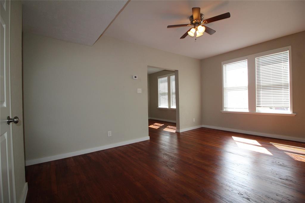 2309 Wesley Street, Unit D Greenville, TX 75401 - Photo 8 of 16 a view of an empty room with window and wooden floor