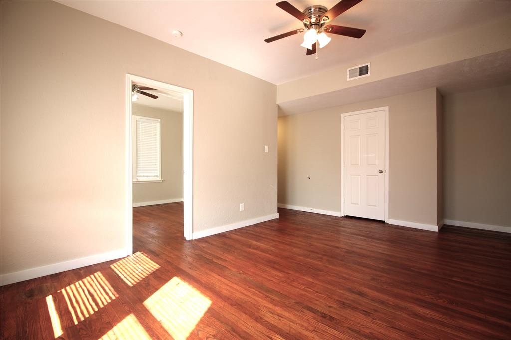 2309 Wesley Street, Unit D Greenville, TX 75401 - Photo 10 of 16 a view of an empty room with window and wooden floor