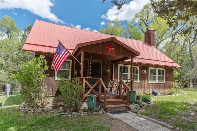a view of a house with yard and sitting area