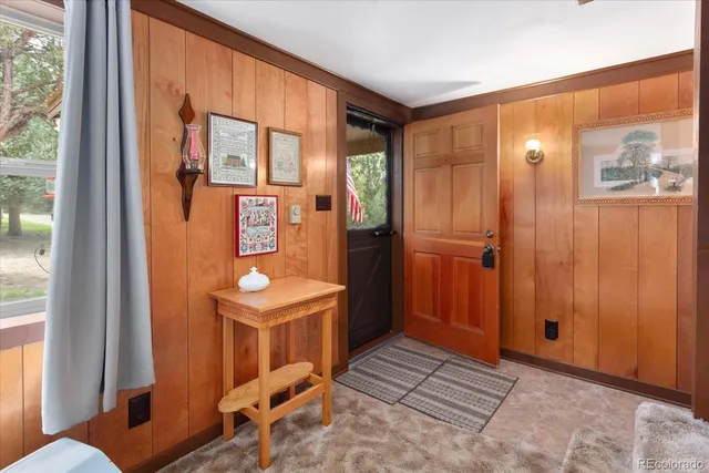 a living room with furniture a flat screen tv and a large window