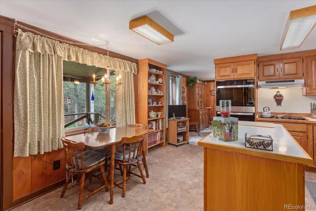 a dining room with furniture and a floor to ceiling window