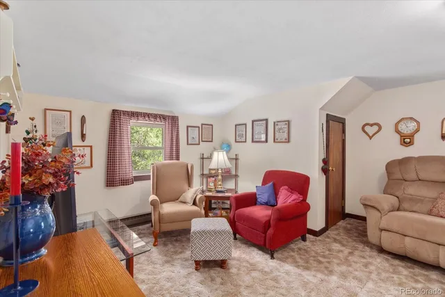 a living room with furniture a couch and a bookshelf