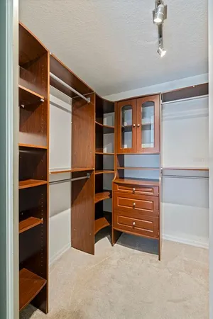 a view of walk in closet with empty racks