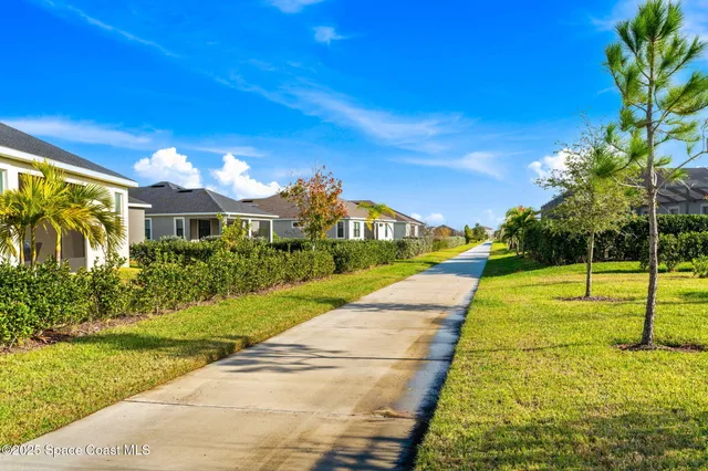 an aerial view of a house with a yard and outdoor seating