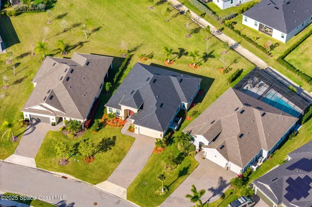 an aerial view of residential houses with outdoor space