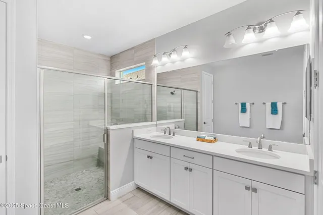 a bathroom with a shower sink double and mirror