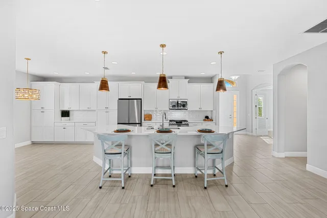 a kitchen with a sink cabinets and wooden floor