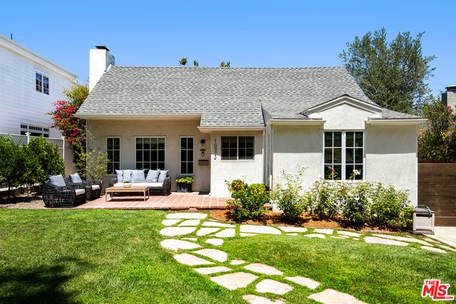 a front view of a house with a yard table and chairs