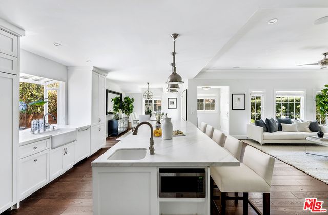 a dining room with furniture a chandelier and wooden floor