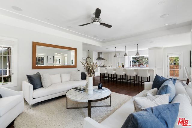 a large white kitchen with lots of counter space and stainless steel appliances