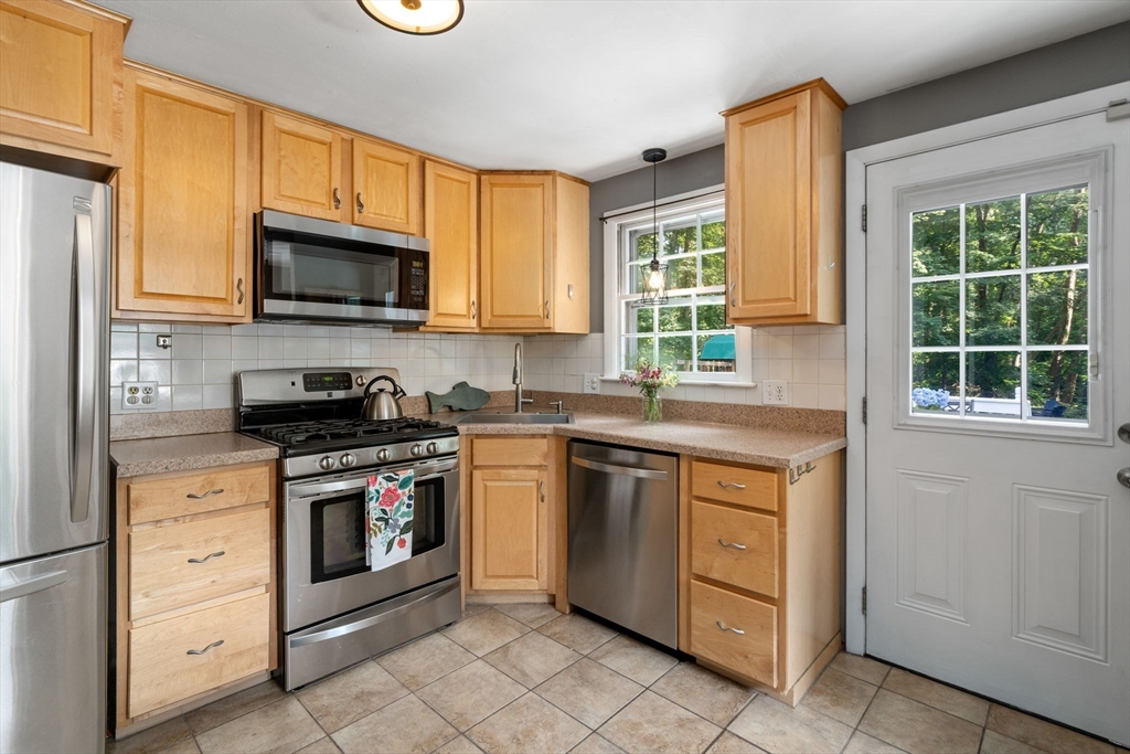330 Gorwin Drive Holliston, MA 01746 - Photo 8 of 27 a kitchen with stainless steel appliances granite countertop a stove sink and microwave