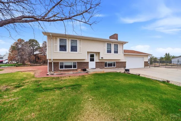 a front view of house with yard and outdoor seating