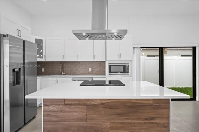 a kitchen with a refrigerator a stove a microwave and cabinets