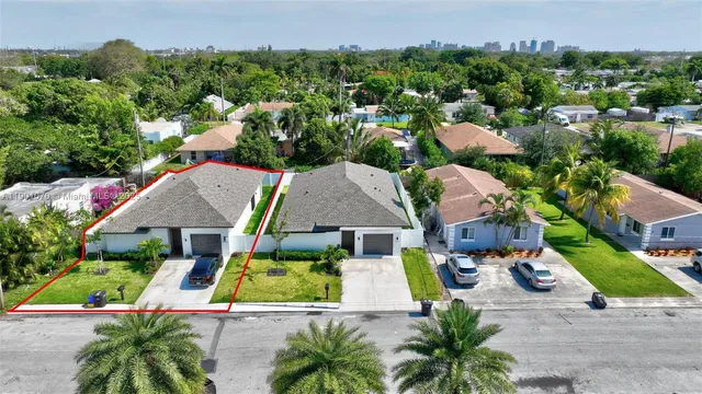 an aerial view of multiple houses with yard