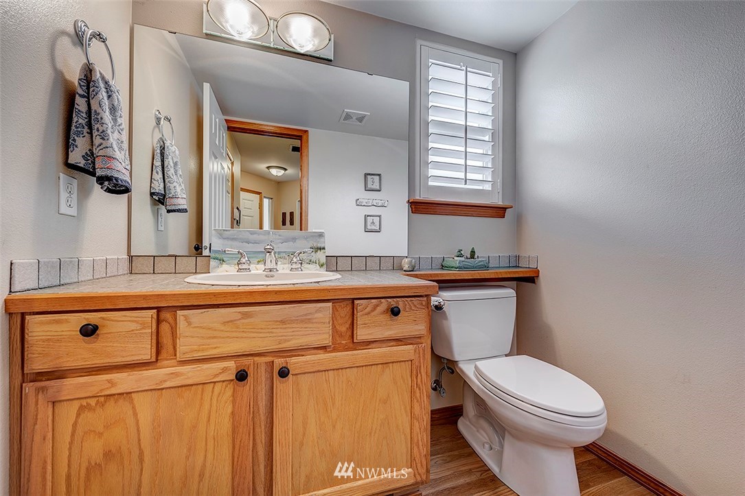 17029 4th Avenue Southeast Bothell, WA 98012 - Photo 16 of 23 a bathroom with a sink a toilet and mirror