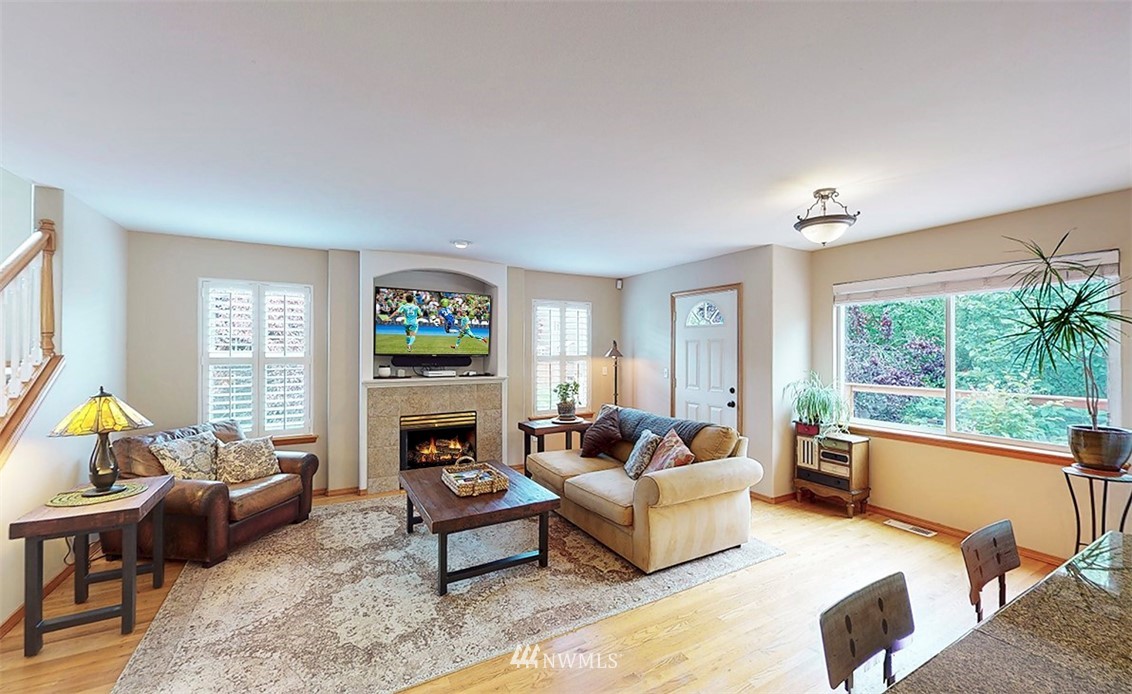 17029 4th Avenue Southeast Bothell, WA 98012 - Photo 4 of 23 a living room with fireplace furniture and a large window