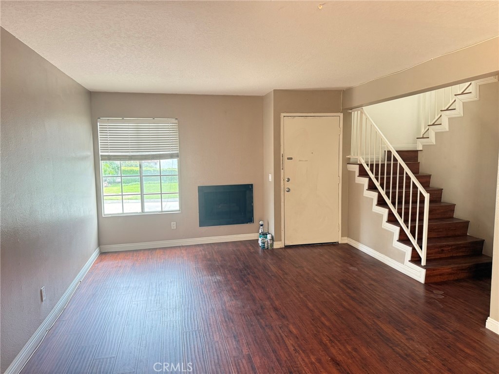 77 North Michigan Avenue, Unit 3 Pasadena, CA 91106 - Photo 4 of 10 a view of an empty room with wooden floor and a window