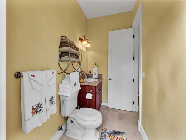 a bathroom with a toilet and a mirror