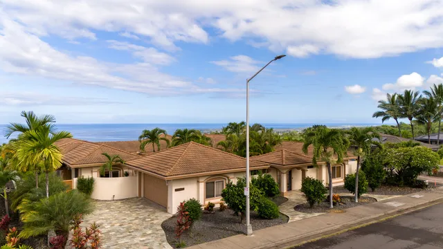a view of a house with porch and garden