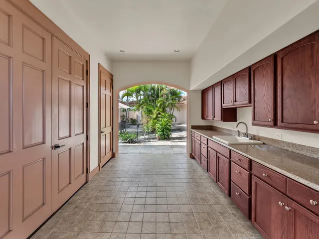 a large kitchen with kitchen island granite countertop a large counter top stainless steel appliances and cabinets