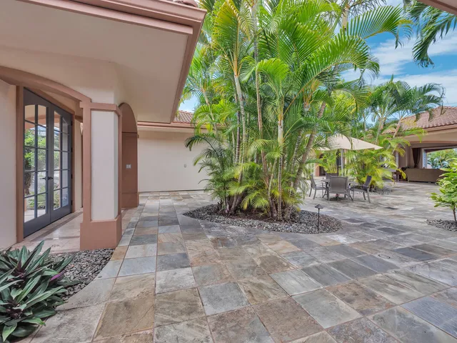 a view of backyard with outdoor seating and plants