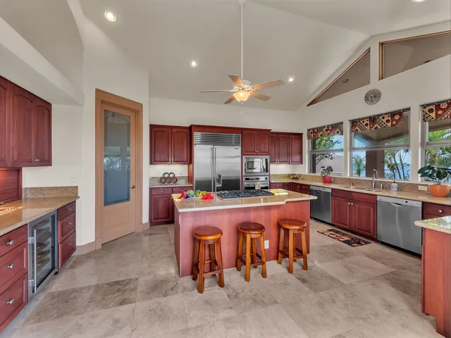 a large kitchen with a large counter top appliances and cabinets