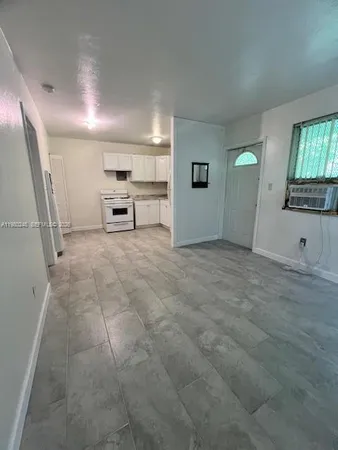 a white stove top oven sitting inside of a kitchen