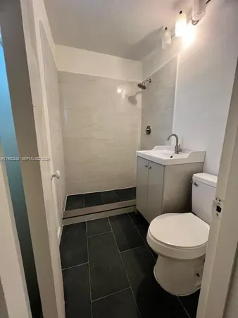 an empty room with windows and mirror