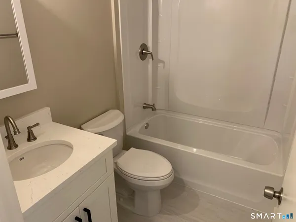a bathroom with a toilet sink and shower