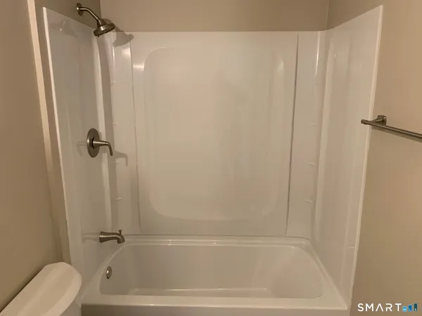 a bathroom with a shower and a toilet