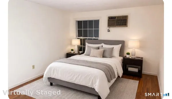 a bedroom with a bed and a tv