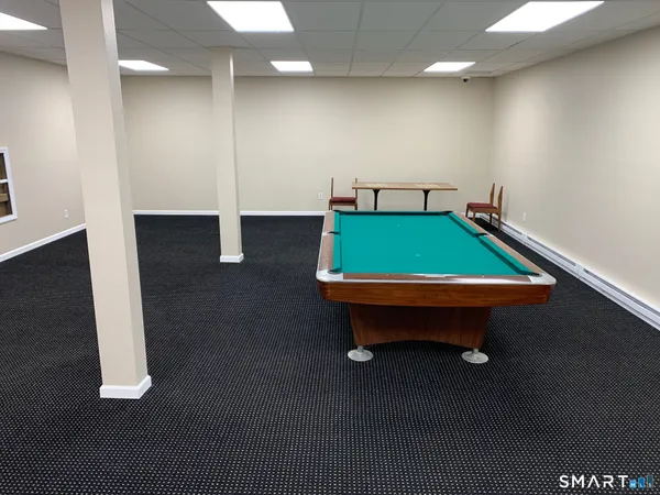 a room with pool table and windows