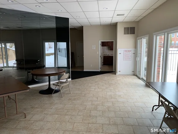 a building outdoor space with patio furniture and a grill