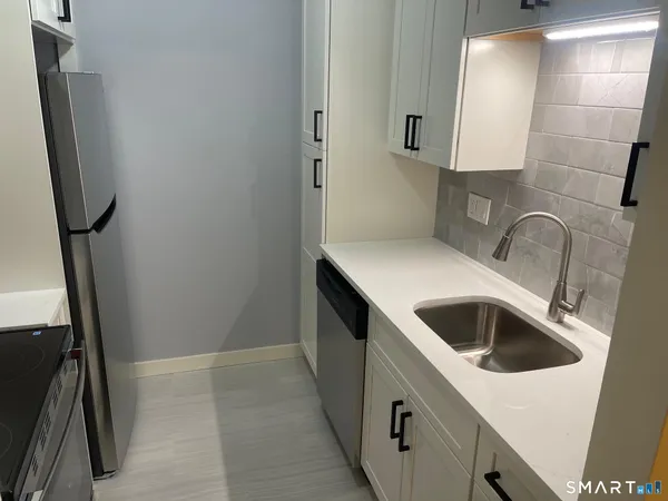 a kitchen with a sink and a washer dryer