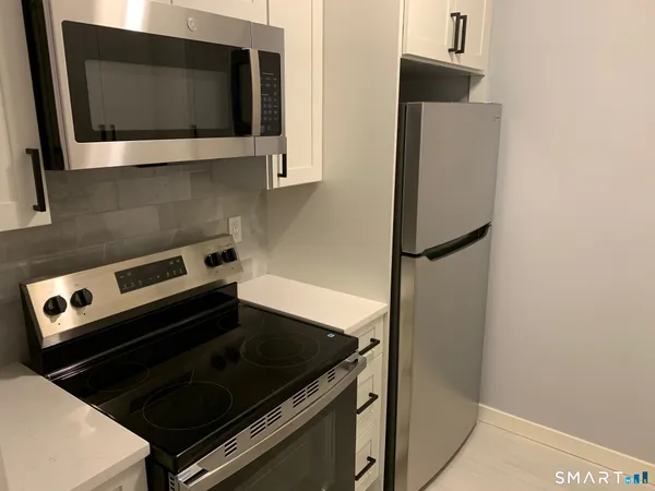 a kitchen with a stove and a microwave