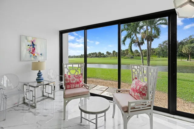 a reading room with furniture and large windows