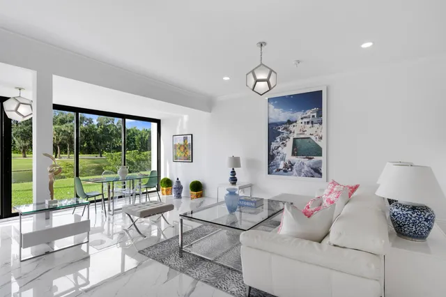 a living room with furniture and kitchen view