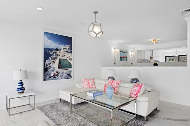 a living room with furniture and kitchen view